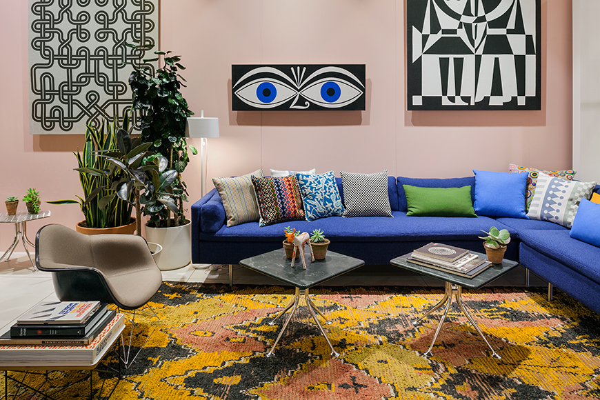 A new Bolster sofa by BassamFellows upholstered in Girard's Superweave textile from Maharam and an Eames Upholstered Molded Fiberglass Arm Chair on a "cat's cradle" base offer visitors a place to lounge.