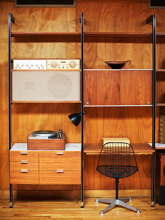 An original Nelson CSS system is outfitted with a Rek-O-Kut record player designed by the Nelson office and paired with an Eames Wire Chair-Contract Base.