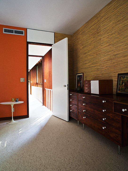 The long, light-filled hallway leads into the master bedroom.