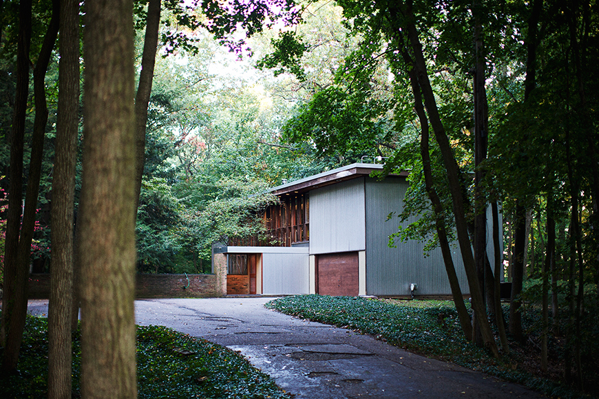 A leafy drive and lush landscape surround the Kirkpatrick House.